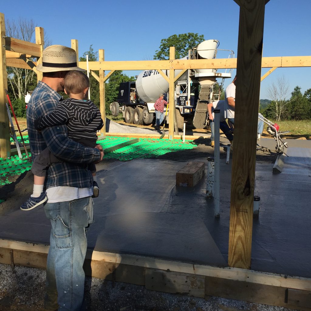 Watching the concrete slab be poured for our off-grid cordwood house