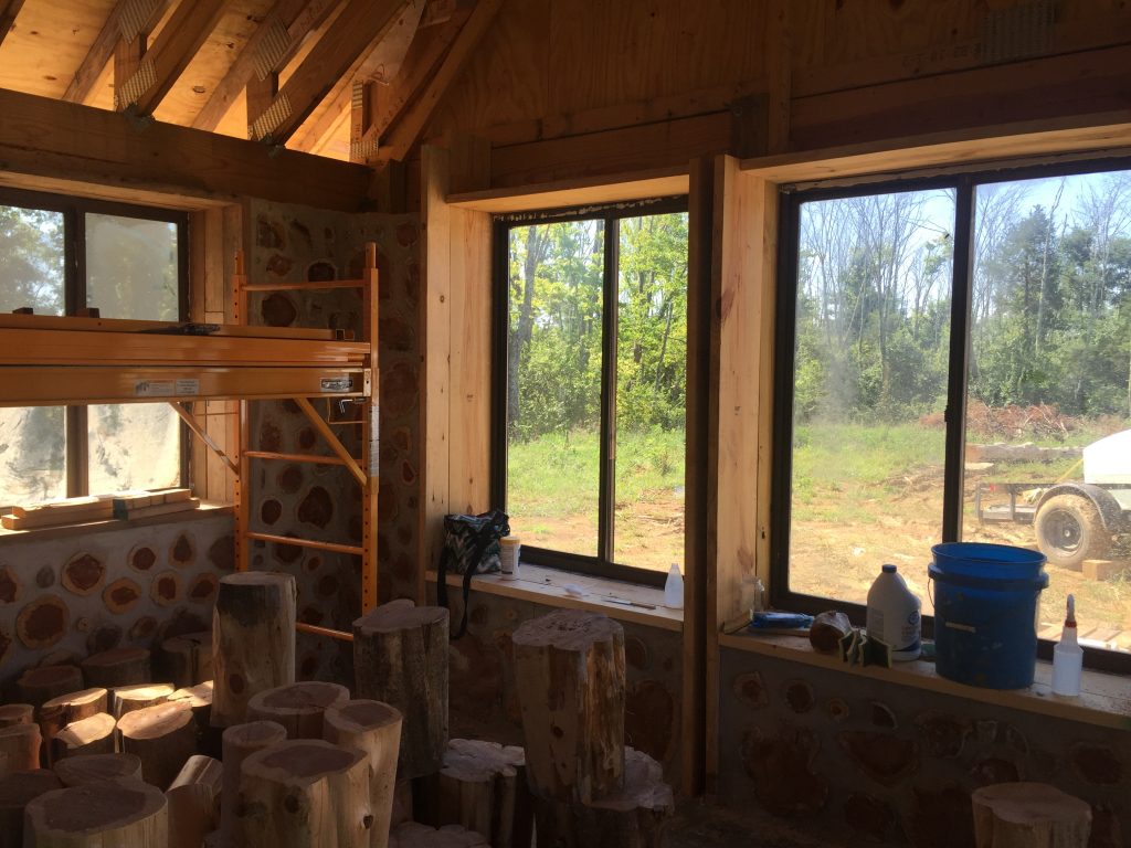Interior of a cordwood house under construction - at Accidental Hippies