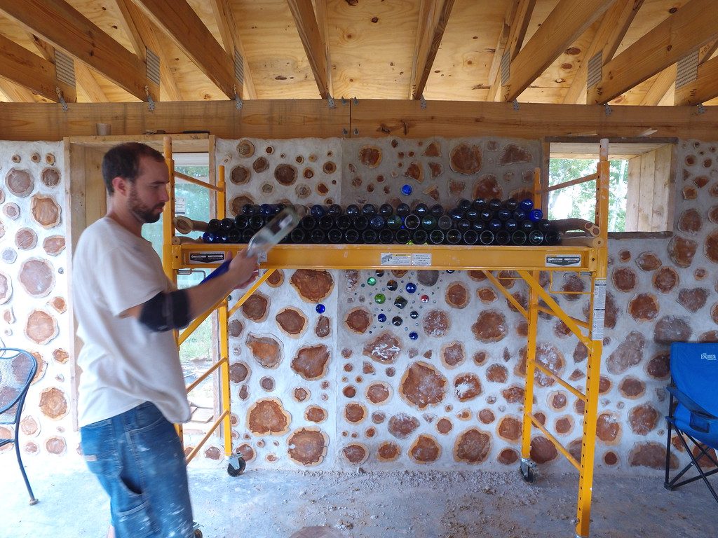 Stacking bottle bricks for use in cordwood walls - accidentalhippies.com