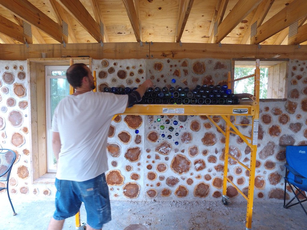 Stacking bottle bricks for use in cordwood walls - accidentalhippies.com