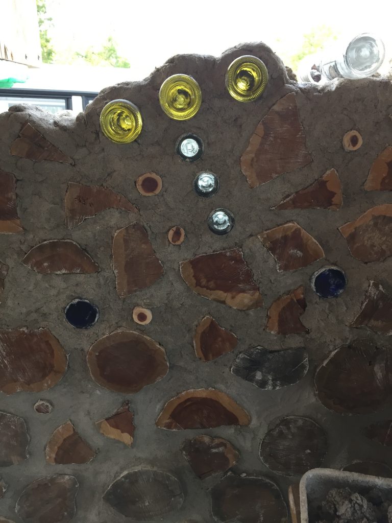 You can use bottle bricks to make designs in a cordwood wall. Here you see the bottom half of the constellation Orion in progress in a wall. 