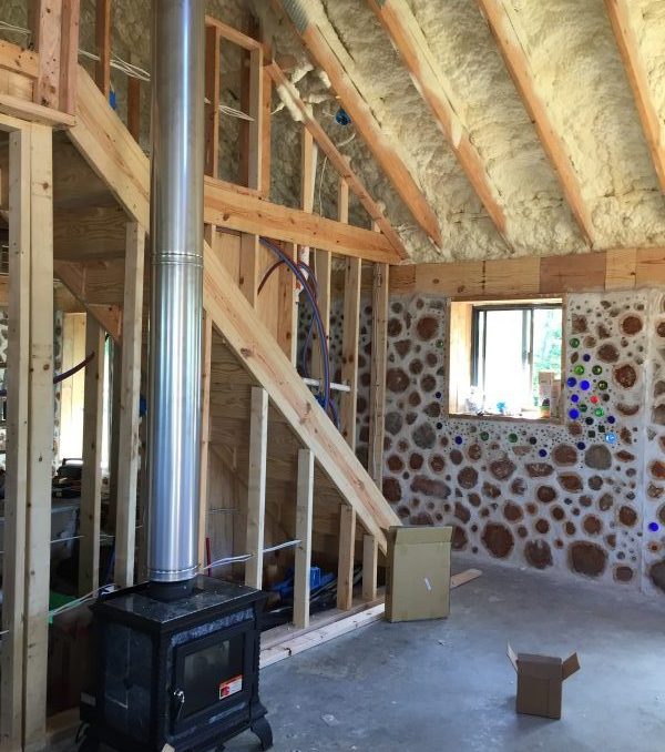 Soapstone stove in a cordwood house. Check out more of our off grid building project!