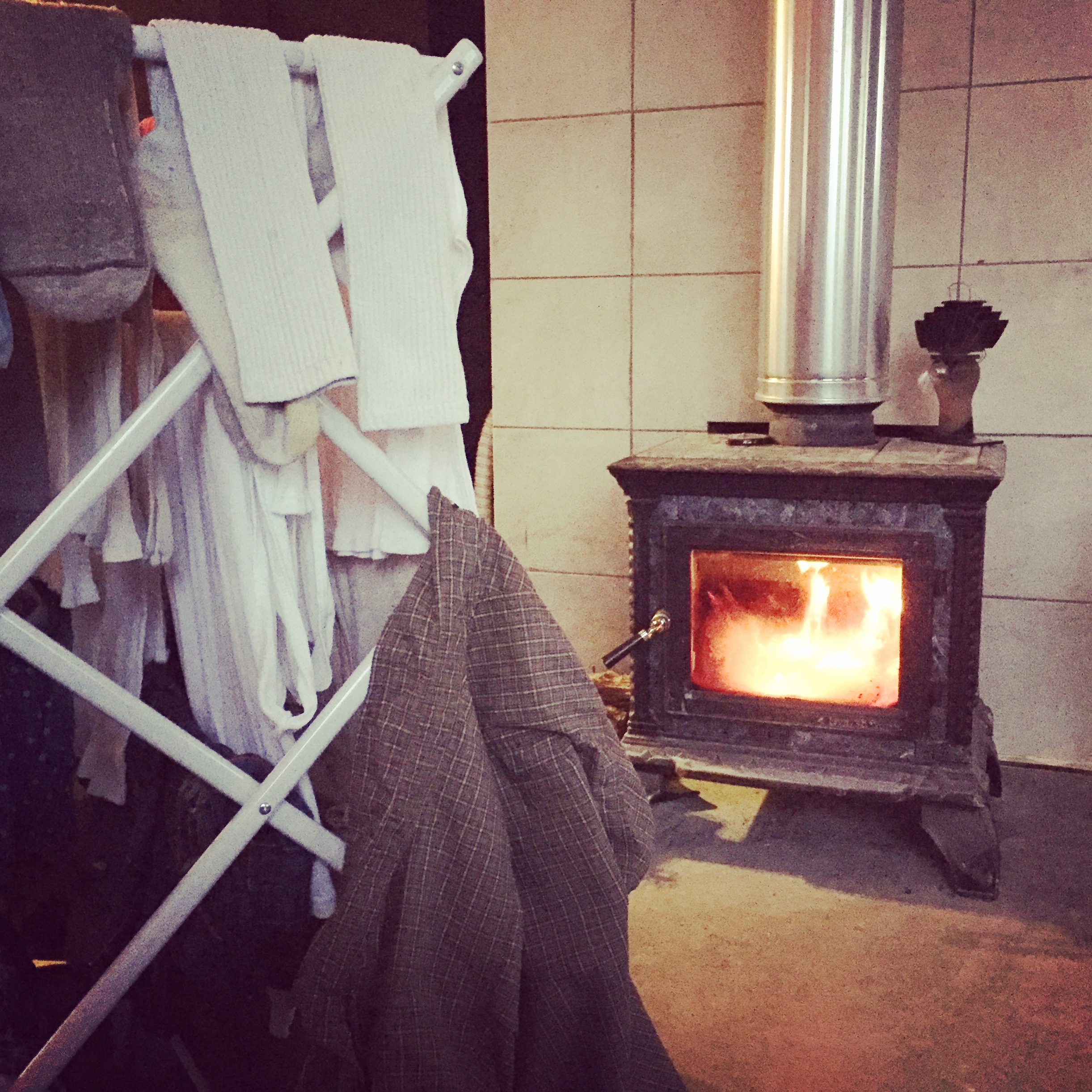 Air drying our clothes by the woodstove is just one way we save power off grid in the winter. What else do we do living with off grid solar?