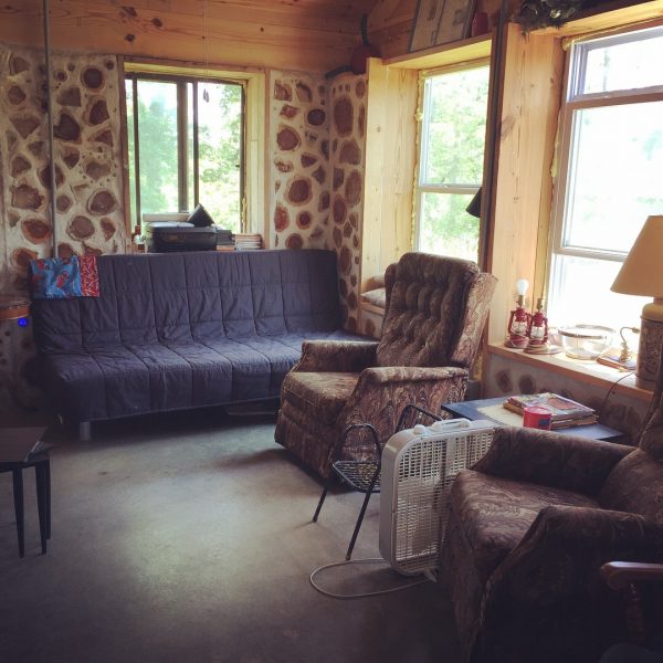 The living room in our cordwood house. Find out more about how we built it here. #cordwood #homesteading #offgrid